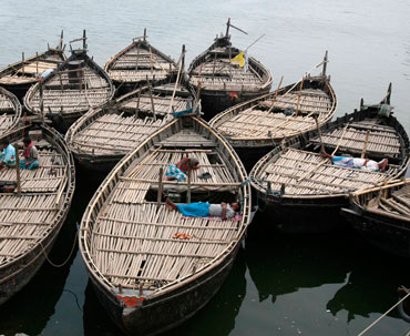 Boat men rest on their boats at Dhulian village in Murshidabad district of the eastern Indian state