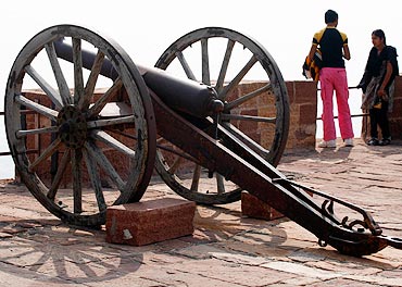Tourists stand beside medieval cannons at the Meharangarh Fort at the historic town of Jodhpur