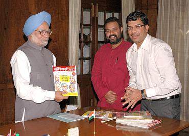 From left: Dr Manmohan Singh with the first copy of the Hindi edition of Careers360 by Editor Mahesh Sarma and Maheshwer Peri