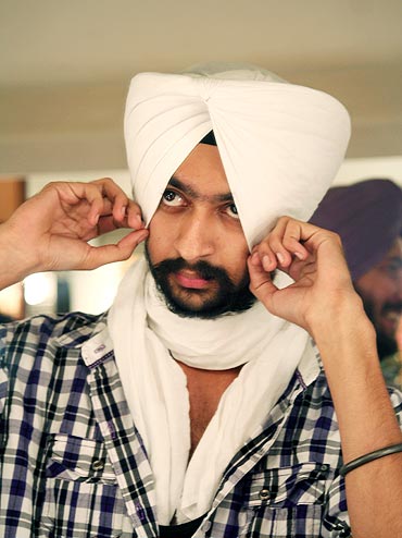 Rajangad Singh adjusts his turban just before setting foot on the stage
