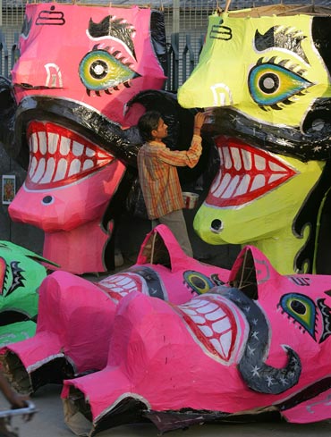 An artist adds the finishing touches to effigies of Ravana in New Delhi.