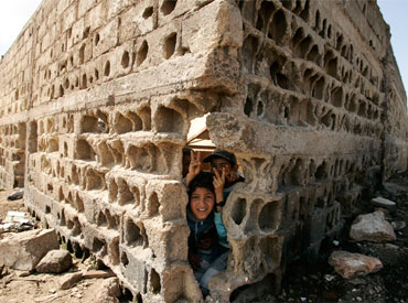Children play by a wall at Tomas slum in Casablanca