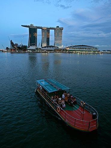 A tourist boat passes the soon to be opened Marina Bay Sands casino in Singapore