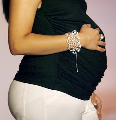 A pregnant model showcases a costume during a maternity fashion show organised by a newly launched company which caters to pregnant women