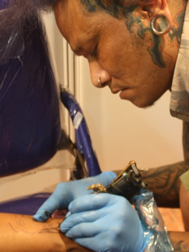A tattoo artist busy at work