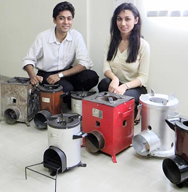 Mathur and Juneja with the various designs that the stove went through