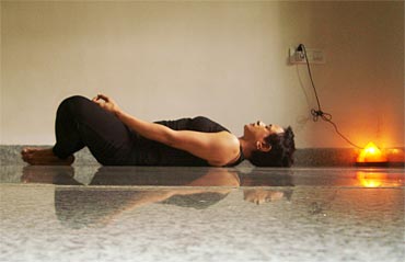 Supta baddhakonasana (lying leg-locked angle pose)