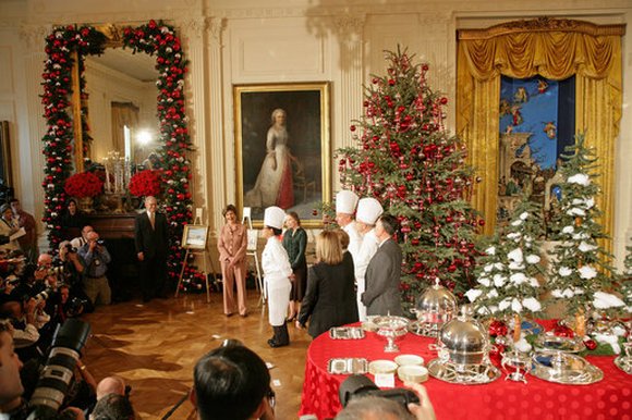 Decide on your menu well in advance so you're all set to host a grand party. Here, Laura Bush and White House Chef Cris Comerford, center, explain the holiday reception menu to the press in the State Dining Room