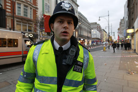 Police maintain a security cordon following a fatal stabbing on Oxford Street in London December 26, 2011.  A male was pronounced dead at the scene and a number of arrests had been made, police said.