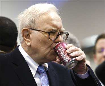 Buffett drinks a can of Cherry Coke. Berkshire Hathaway owns about 8.7 percent of Coca-Cola.