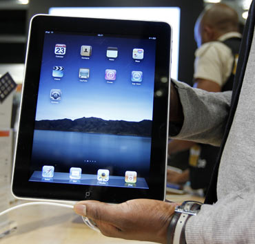 A salesman displays an Apple iPad during its launch in Brussels July 23, 2010