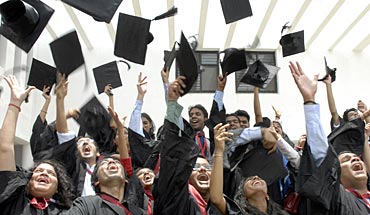 Students of the graduating class of the National Academy of Legal Studies and Research (NALSAR), University of Law, throw their caps in the air as they participate in their farewell cheer in the southern Indian city of Hyderabad July 21, 2007