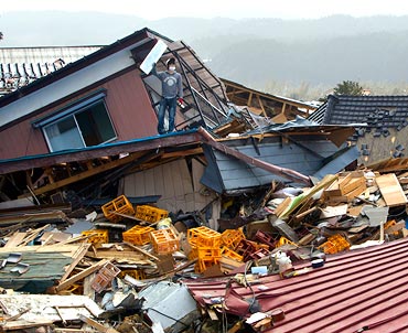 A man tries to salvage personal items from his destroyed home March 20, 2011 in Ofunato, Japan. More than a week after the magnitude 9 earthquake and tsunami struck Japan the death toll has risen to 8,200 dead with still thousands missing.