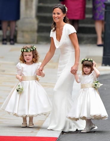 Maid of honour Pippa Middleton holds hands with bridesmaids Grace Van Cutsem and Eliza Lopes as they arrive to attend the Royal Wedding of Prince William to Catherine Middleton at Westminster Abbey on April 29, 2011 in London, England