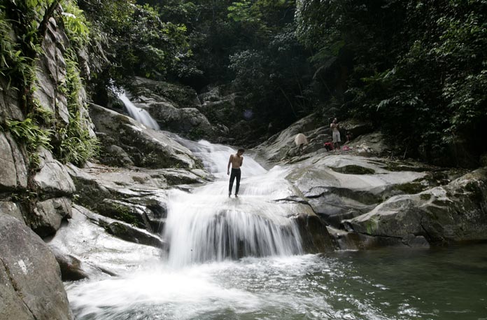 A man stands at Lopo Waterfall in Hulu Langat near Kuala Lumpur