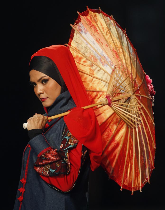 A model presents a creation from the 'Shades of Qipao' collection by Hajaba of Malaysia