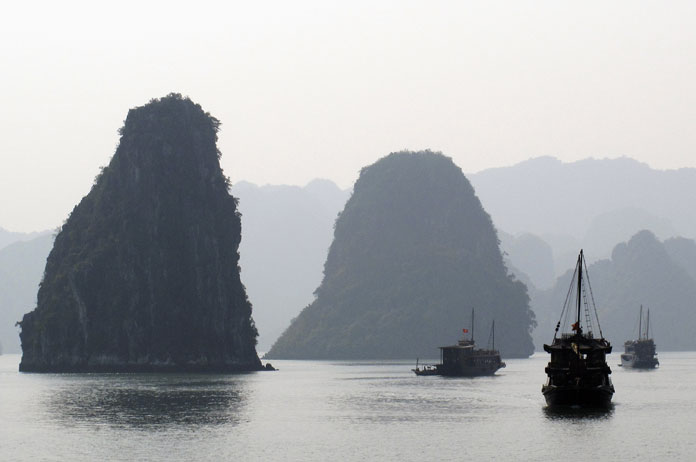Tourist boats cruise in  Vietnam's scenic Halong Bay.