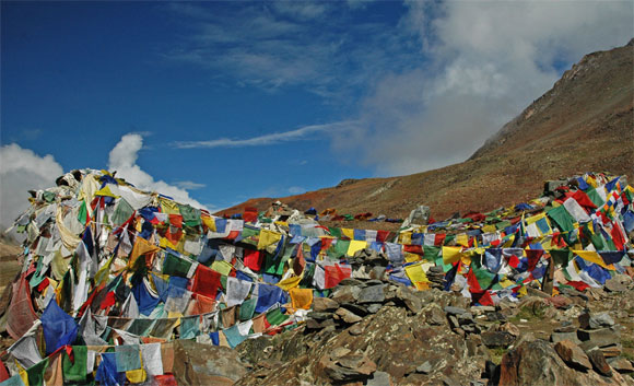 Tibetan Budhist prayer flags in five colours flutter in the wind near Barlacha La pass along the Manali Leh Highway