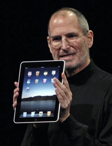 Apple Chief Executive Officer Steve Jobs holds the new  iPad during the launch of Apple's new tablet computing device in San Francisco, California, January 27, 2010.