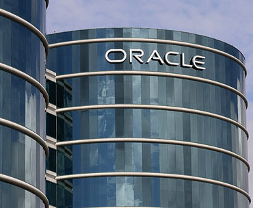 The Oracle logo is displayed on the company's headquarters in Redwood Shores, California.