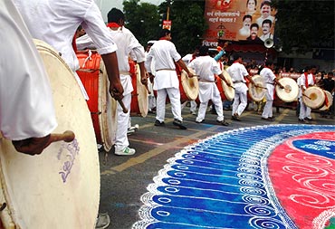 Traditional musicians play dhols en route to Kasba ganpati's immersion