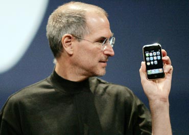 Apple Computer Inc. Chief Executive Officer Steve Jobs holds the new iPhone in San Francisco, California January 9, 2007
