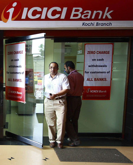 A man leaves an automated teller machine (ATM) facility of ICICI bank in the southern Indian city of Kochi August 6, 2009.