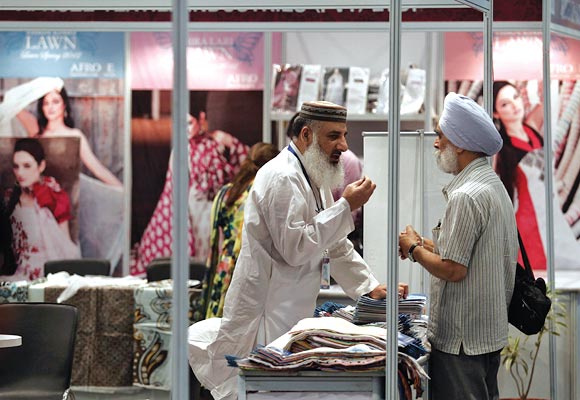 A Pakistan exhibitor (L) speaks with an Indian Sikh visitor at the Lifestyle Pakistan Exhibition in New Delhi April 12, 2012. From gourmet chefs to fashion houses showcasing muslin suits on the catwalk, Pakistan will unveil a trade fair in New Delhi on Thursday to reveal a soft side to traditional foe India as commercial ties between the nuclear-armed rivals begin to bloom.