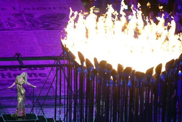 Model Kate Moss poses in front of the Olympic Cauldron during the Closing Ceremony at the London 2012 Olympic Games at the Olympic Stadium on August 12, 2012 in London, England