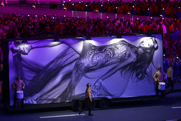 A billboard featuring the image of model Naomi Campbell is displayed at the start of the fashion show