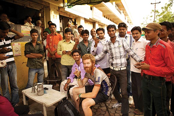 Sean Conway takes a break at a tea stall in Amravati, India