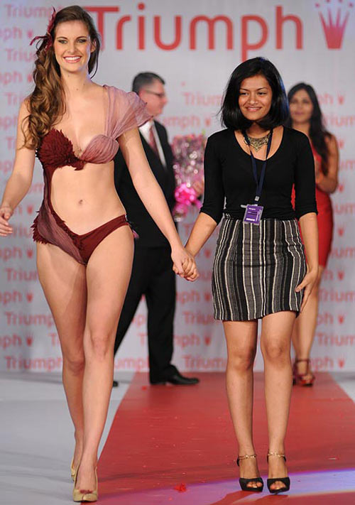 Pooja Upadhyay (right) takes to the ramp with her winning creation at the Indian leg of the Triumph Inspiration Awards 2012 in Mumbai, May 2