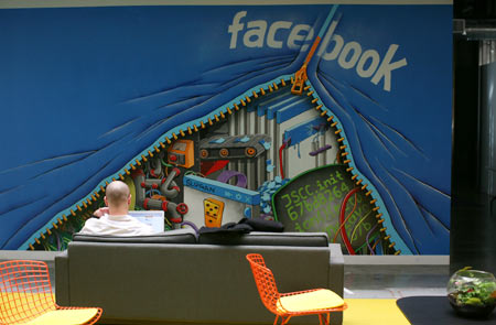 An employee works on a computer at the new headquarters of Facebook in Menlo Park, California January 11, 2012. The 57-acre campus, which formerly housed Sun Microsystems, features open work spaces for nearly 2,000 employees on the one million square foot campus, with room for expansion. Picture taken January 11, 2012.