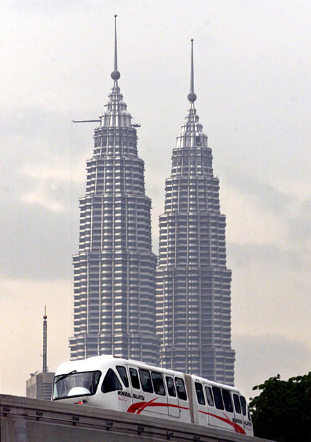 The new Monorail Malaysia train passes the Petronas Twin Towers during a test run in Kuala Lumpur.