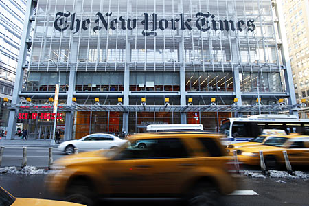 Vehicles drive past the New York Times headquarters in New York.