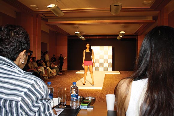 A model poses while judges Anjana Sharma (left) and Purnima Lamba (right) look on