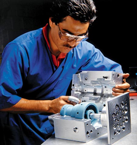 A professional works on the design of a plastic mould