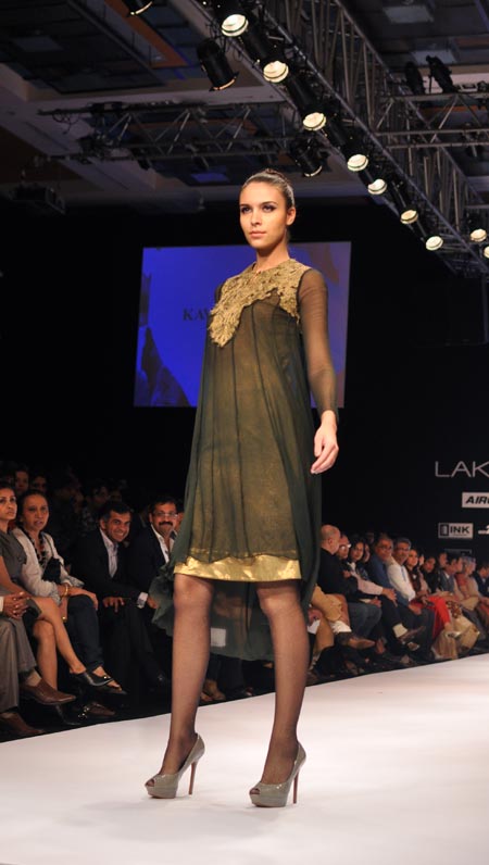 A model walks the ramp in Kavita Bhartia's golden-black cocktail dress.