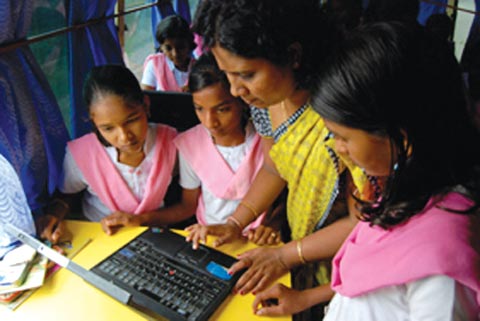 Students attend a computer education class in the mobile B-school