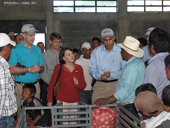 Dr Rajiv Shah talks with farmers about processing produce in new packing shed in Sacapulas, Quiche, Guatemala
