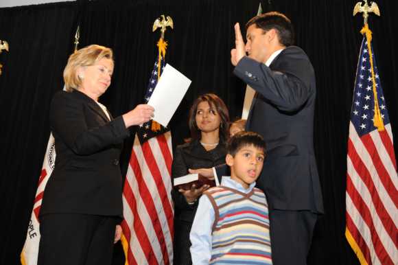 Secretary of State Hillary Rodham Clinton administers the oath of office to USAID Administrator Rajiv Shah in Washington, D.C., Jan. 7, 2010, as his family looks on.