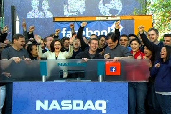 Sheryl Sandberg, third from left, with Facebook founder Mark Zuckerberg ring the NASDAQ stockmarket Opening Bell remotely from Facebook headquarters in Menlo Park, California, May 18