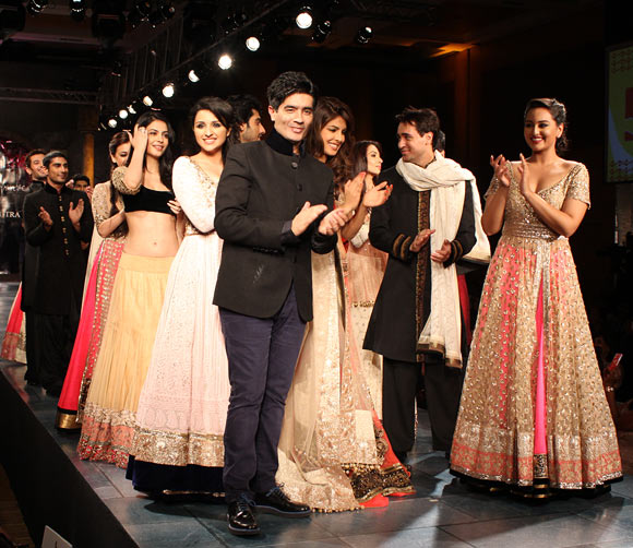 Manish Malhotra (front, left) escorts his celebrity muses onto the ramp