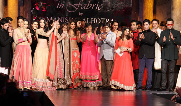 Shabana Azmi (sixth from left, front row) applauds Manish Malhotra (second from right), front row as the celebrities look on