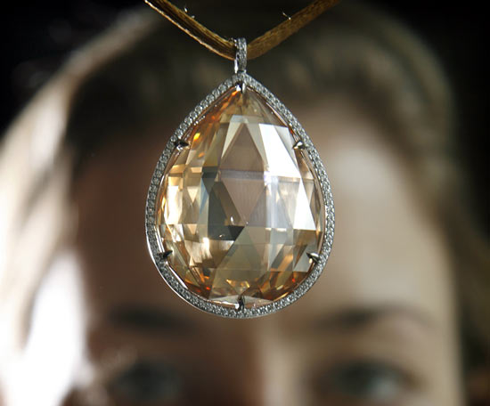 Christie's Jewellery specialist Helen Molesworth holds up a coloured diamond pendant during an auction preview in Geneva May 11, 2007.