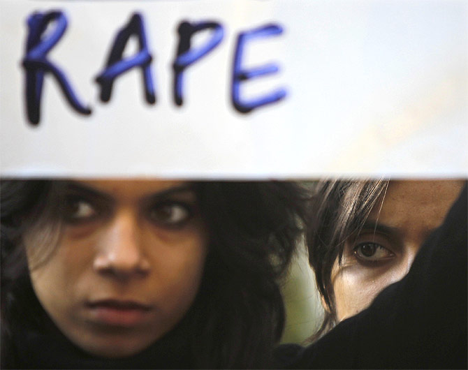 A protester holds a placard during a rally demanding the state government to ensure the safety of women in the capital city, outside the residence of Delhi's Chief Minister Sheila Dixit in New Delhi December 19, 2012.