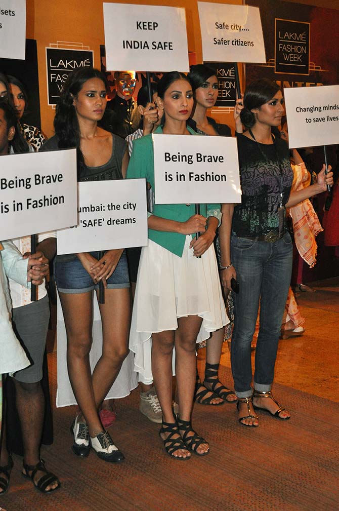 Models hold out placards to protest against the Mumbai rape at the ongoing Lakme Fashion Week