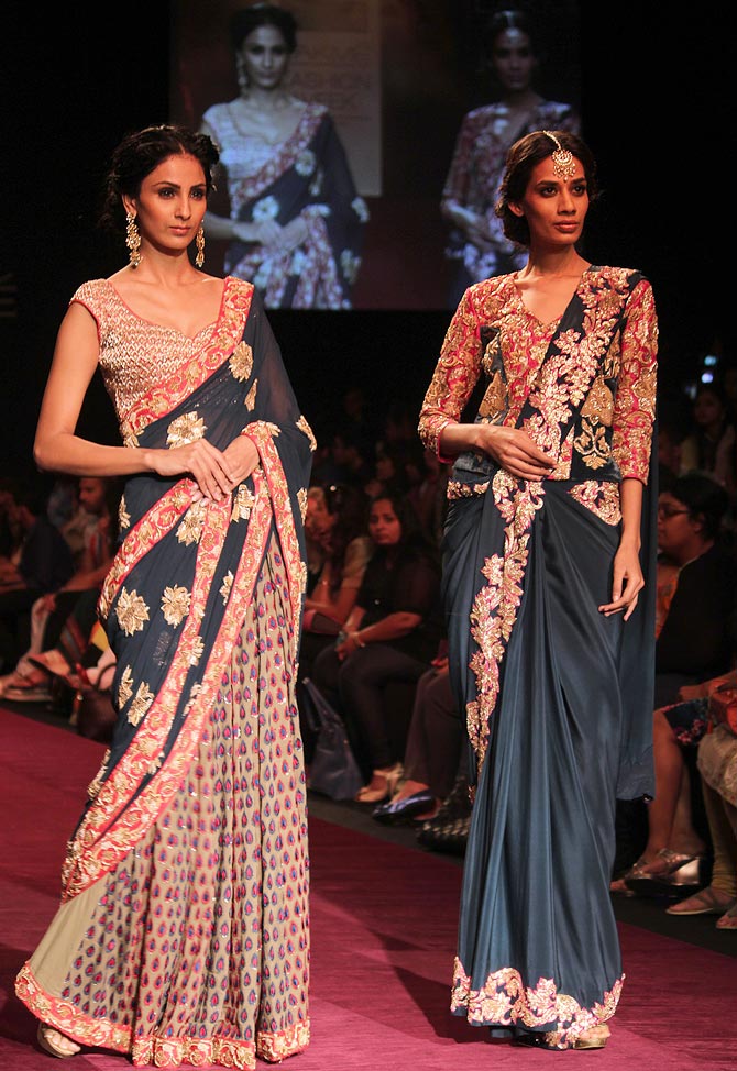 Models showcase a Shyamal and Bhumika creation.