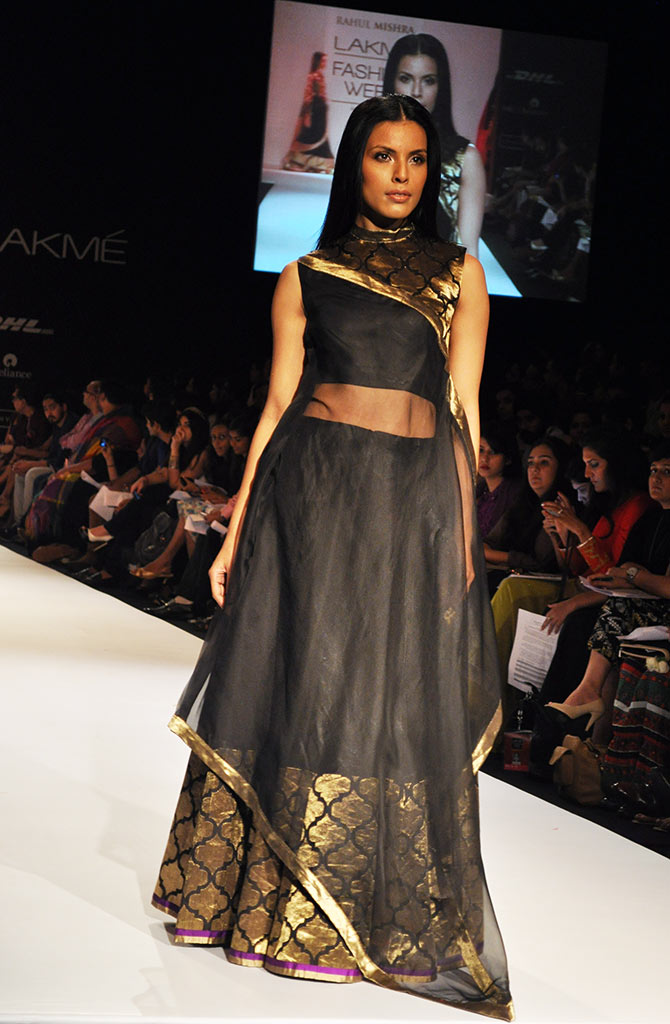 A model wears one of Rahul Mishra handloom collection in black and gold.