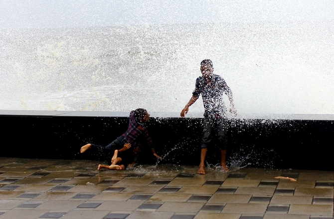 Children have a ball as huge waves hit the promenade at Mumbai's Worli Sea Face.
